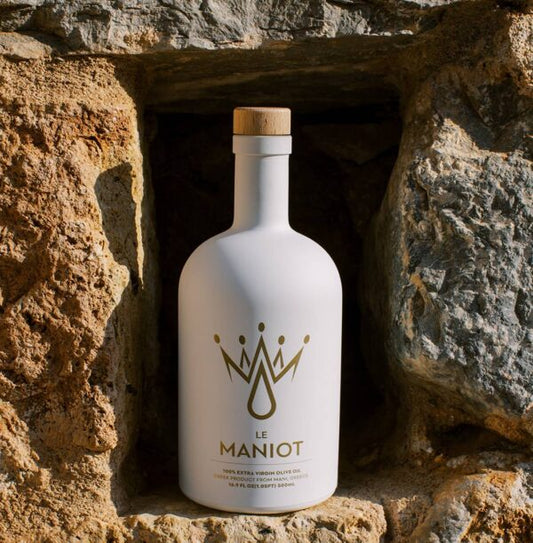 Le Maniot Original 500mL in Mani stone niche. Greek product from Mani, harvest-dated bottle.