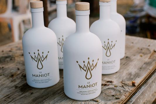 le maniot olive oil on rustic olive grove table